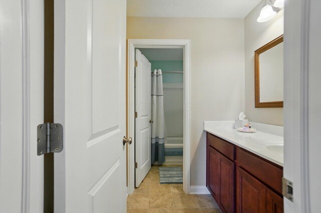 6368 Casado Dr, Columbus, OH 43213 - full bath with vanity, shower / tub combo with curtain, tile patterned floors, and baseboards
