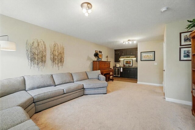6368 Casado Dr, Columbus, OH 43213 - living room featuring light carpet, baseboards, and a textured ceiling