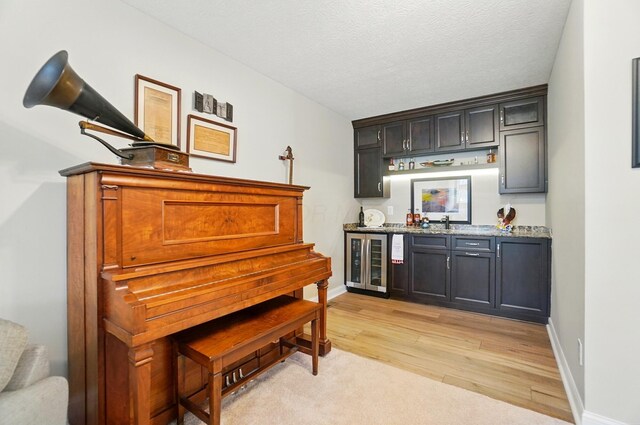 6368 Casado Dr, Columbus, OH 43213 - indoor wet bar with wine cooler, light wood-style floors, and baseboards
