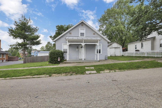 115 N Walnut St, Baltimore, OH 43105 - view of front of property featuring a porch, an outdoor structure, and a standing seam roof
