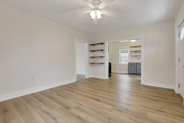 115 N Walnut St, Baltimore, OH 43105 - unfurnished living room with ceiling fan, baseboards, and light wood-style flooring