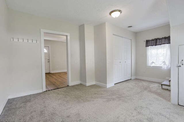 115 N Walnut St, Baltimore, OH 43105 - unfurnished bedroom with carpet, baseboards, a closet, and a textured ceiling