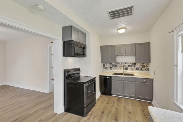 115 N Walnut St, Baltimore, OH 43105 - kitchen featuring black appliances, a sink, gray cabinets, light wood-style flooring, and a textured ceiling
