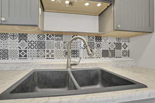 115 N Walnut St, Baltimore, OH 43105 - kitchen view of a sink, decorative backsplash, light stone countertops, and gray cabinetry