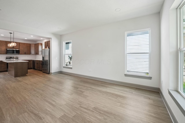 63 Hayden Ave, Columbus, OH 43222 - unfurnished living room with light wood finished floors and recessed lighting