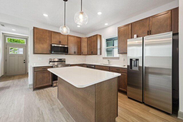 63 Hayden Ave, Columbus, OH 43222 - kitchen featuring appliances with stainless steel finishes, light wood finished floors, light countertops, decorative light fixtures, and recessed lighting