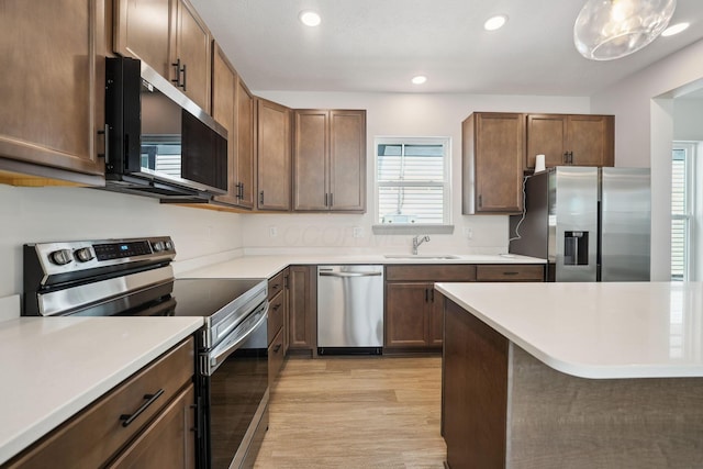 63 Hayden Ave, Columbus, OH 43222 - kitchen with stainless steel appliances, light wood-style floors, recessed lighting, and light countertops