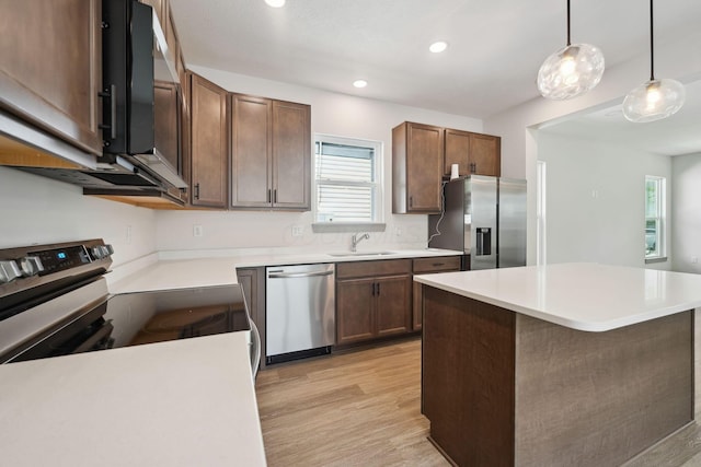 63 Hayden Ave, Columbus, OH 43222 - kitchen featuring stainless steel appliances, light wood-type flooring, light countertops, hanging light fixtures, and recessed lighting