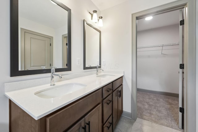 63 Hayden Ave, Columbus, OH 43222 - bathroom with double vanity, a walk in closet, and tile patterned flooring