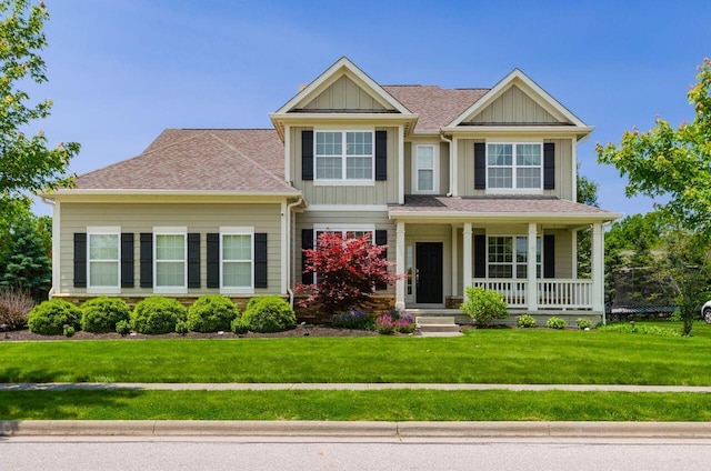 1201 Stone Trail Dr, Blacklick, OH 43004 - view of front of property with board and batten siding, covered porch, a front yard, and a shingled roof