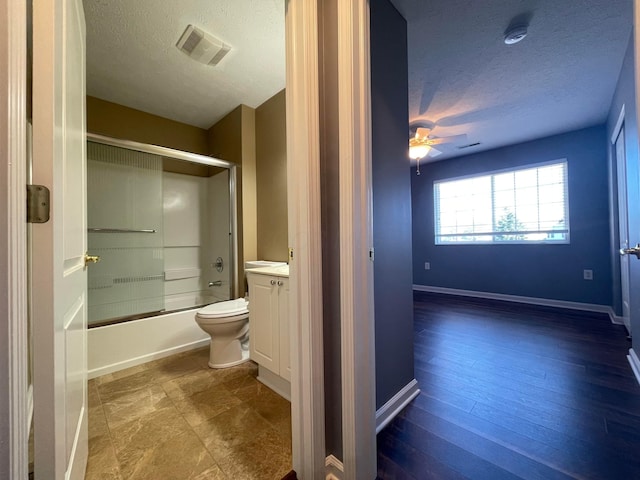 2001 Berrancher Dr, Columbus, OH 43228 - full bath with a textured ceiling, toilet, bath / shower combo with glass door, vanity, and ceiling fan