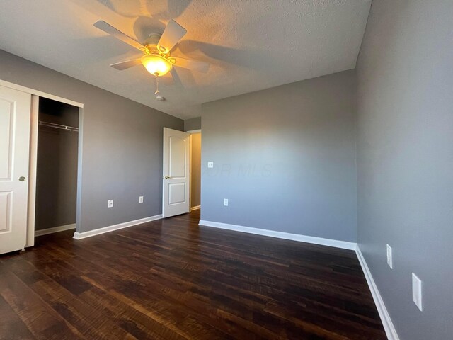2001 Berrancher Dr, Columbus, OH 43228 - unfurnished bedroom featuring dark wood finished floors, baseboards, a closet, and a ceiling fan