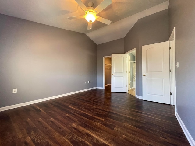 2001 Berrancher Dr, Columbus, OH 43228 - unfurnished bedroom with dark wood-type flooring, a spacious closet, vaulted ceiling, baseboards, and a ceiling fan