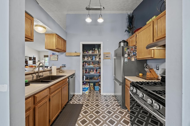 993 Esther Dr, Columbus, OH 43207 - kitchen featuring appliances with stainless steel finishes, under cabinet range hood, a sink, light countertops, and a textured ceiling