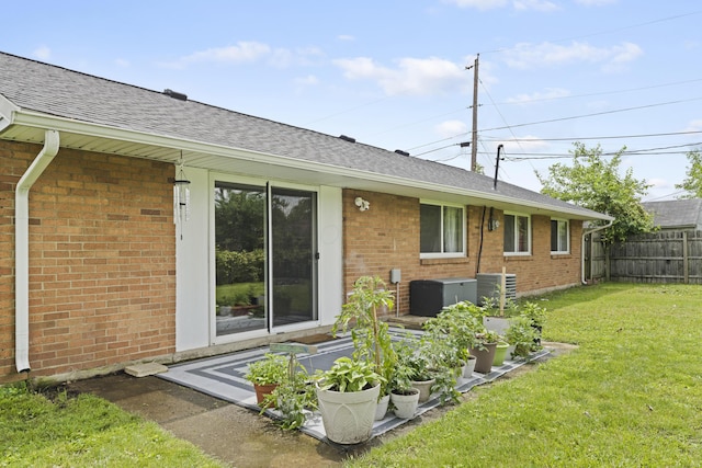 6576 Creon Dr, Reynoldsburg, OH 43068 - back of property with brick siding, a shingled roof, and central air condition unit