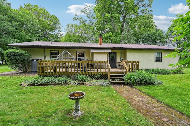 6769 Thoreau Ln NE, Baltimore, OH 43105 - ranch-style house featuring stucco siding, a front lawn, metal roof, and a deck