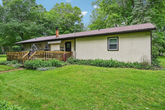 6769 Thoreau Ln NE, Baltimore, OH 43105 - back of house featuring stucco siding, a yard, metal roof, and a deck