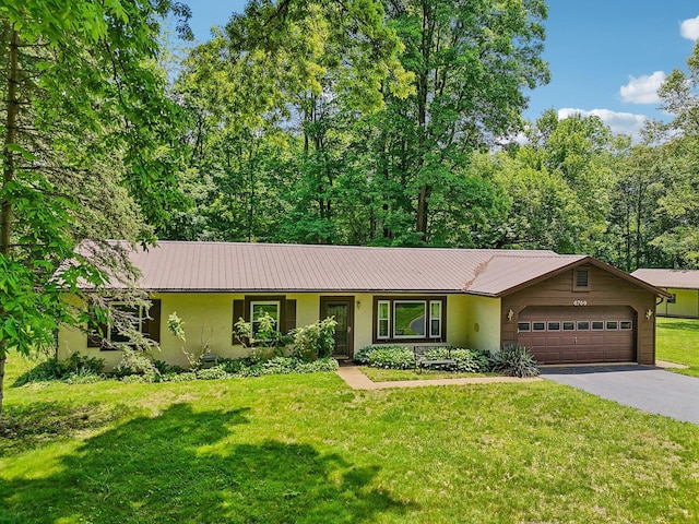 6769 Thoreau Ln NE, Baltimore, OH 43105 - ranch-style house featuring stucco siding, asphalt driveway, an attached garage, and a front lawn
