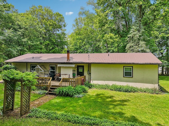 6769 Thoreau Ln NE, Baltimore, OH 43105 - rear view of property featuring stucco siding, a lawn, and metal roof