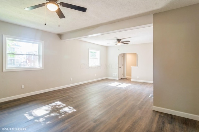 823 S Walnut St, Bucyrus, OH 44820 - empty room with a ceiling fan, arched walkways, wood finished floors, baseboards, and a textured ceiling