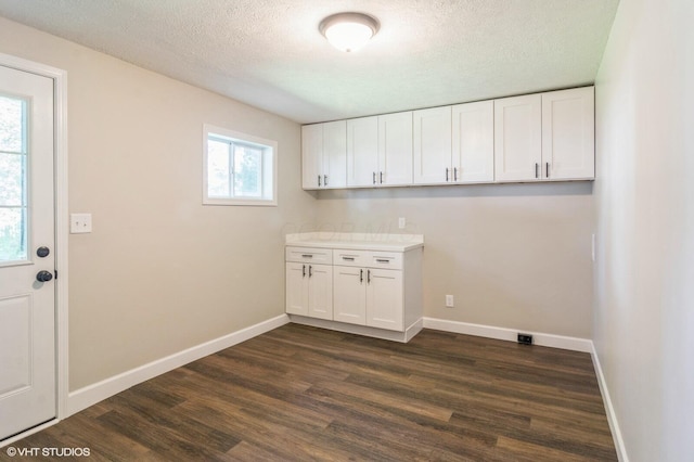 823 S Walnut St, Bucyrus, OH 44820 - laundry room featuring dark wood-style floors, a textured ceiling, and baseboards