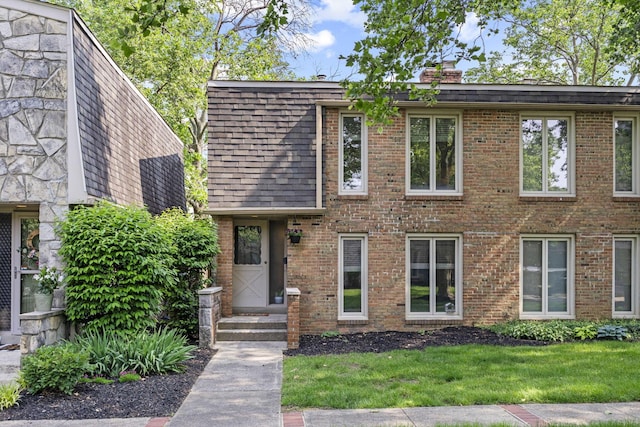 3600 Reed Rd Unit 13, Columbus, OH 43220 - view of front of property featuring a chimney, brick siding, a front yard, and a shingled roof