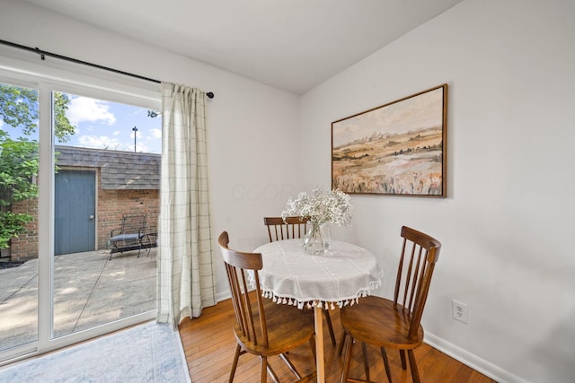 3600 Reed Rd Unit 13, Columbus, OH 43220 - dining space featuring hardwood / wood-style floors, baseboards, and a fireplace