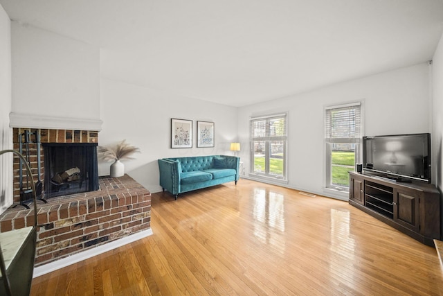 3600 Reed Rd Unit 13, Columbus, OH 43220 - living area featuring wood finished floors and a brick fireplace