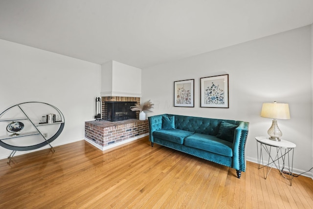 3600 Reed Rd Unit 13, Columbus, OH 43220 - living room with wood finished floors, a brick fireplace, and baseboards