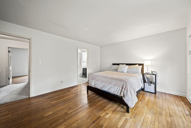 3600 Reed Rd Unit 13, Columbus, OH 43220 - bedroom with hardwood / wood-style flooring, baseboards, and connected bathroom