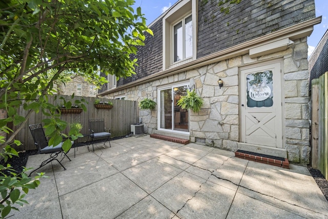 3600 Reed Rd Unit 13, Columbus, OH 43220 - property entrance with a shingled roof, stone siding, mansard roof, and a patio