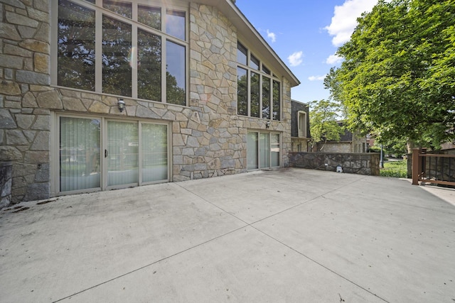 3600 Reed Rd Unit 13, Columbus, OH 43220 - view of side of property featuring stone siding and a patio area