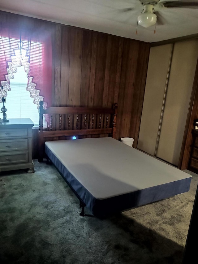 71 Knollwood Ct, South Bloomfield, OH 43103 - bedroom with carpet flooring, wooden walls, and a ceiling fan