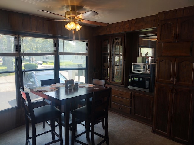 71 Knollwood Ct, South Bloomfield, OH 43103 - dining area featuring a ceiling fan, light floors, and wood walls