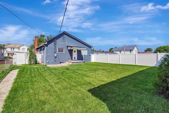 610 Chestnut St, Dresden, OH 43821 - back of house with stucco siding and a fenced backyard