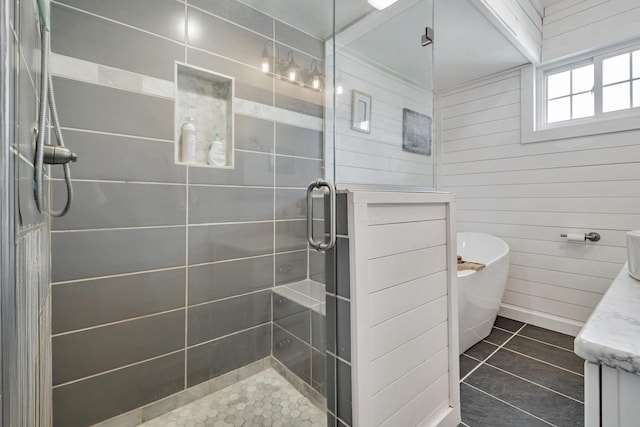 610 Chestnut St, Dresden, OH 43821 - bathroom featuring a stall shower, a soaking tub, wood walls, tile patterned flooring, and vanity