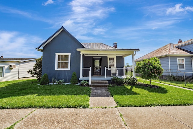 610 Chestnut St, Dresden, OH 43821 - view of front of property featuring covered porch, stucco siding, a chimney, a metal roof, and a wall mounted air conditioner