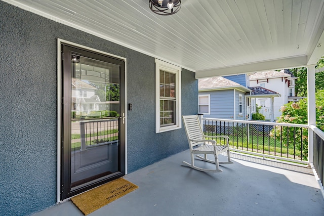 610 Chestnut St, Dresden, OH 43821 - view of exterior entry with stucco siding and a porch