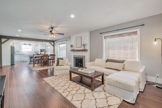 610 Chestnut St, Dresden, OH 43821 - living room with ceiling fan, recessed lighting, a brick fireplace, and dark wood-type flooring