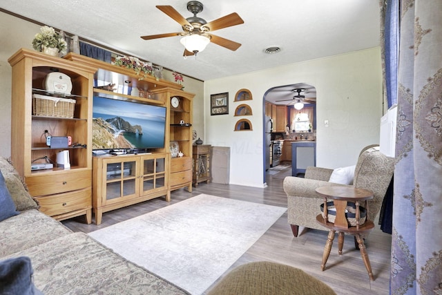 6769 Hildreth Ave, Columbus, OH 43229 - living room with ceiling fan, wood finished floors, and arched walkways
