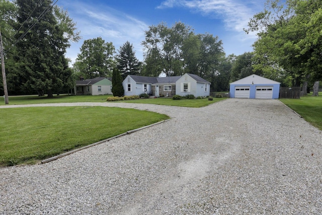 6769 Hildreth Ave, Columbus, OH 43229 - view of front of property with an outbuilding, a front lawn, a detached garage, and view of wooded area
