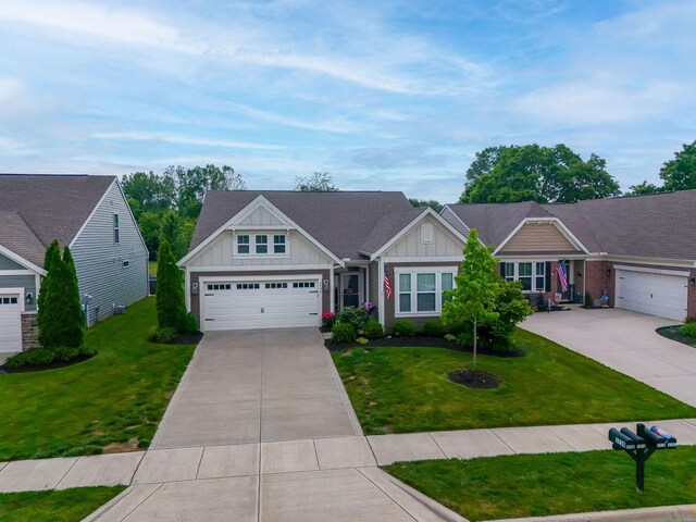 3736 Sanctuary, Hilliard, OH 43026 - view of front of property featuring board and batten siding, concrete driveway, and a front yard