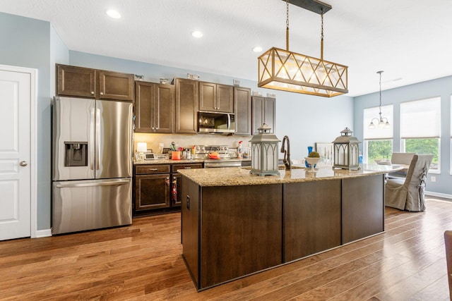 3736 Sanctuary, Hilliard, OH 43026 - kitchen featuring stainless steel appliances, dark wood-type flooring, a chandelier, tasteful backsplash, and pendant lighting