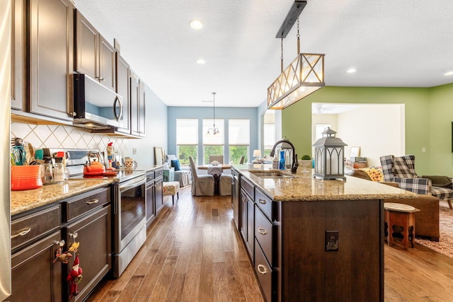 3736 Sanctuary, Hilliard, OH 43026 - kitchen with stainless steel appliances, open floor plan, hardwood / wood-style floors, dark brown cabinetry, and recessed lighting