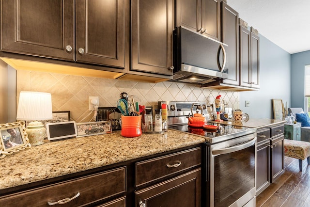 3736 Sanctuary, Hilliard, OH 43026 - kitchen featuring stainless steel appliances, dark brown cabinets, dark wood finished floors, light stone counters, and tasteful backsplash