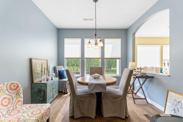 3736 Sanctuary, Hilliard, OH 43026 - dining space featuring a chandelier, wood finished floors, and arched walkways