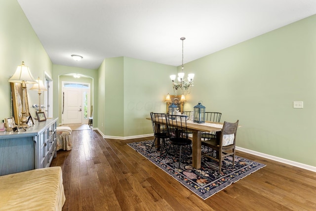 3736 Sanctuary, Hilliard, OH 43026 - dining room featuring arched walkways, dark wood-style flooring, and a chandelier