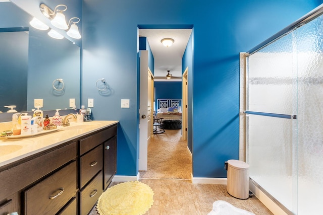 3736 Sanctuary, Hilliard, OH 43026 - ensuite bathroom featuring double vanity, a shower stall, and a ceiling fan