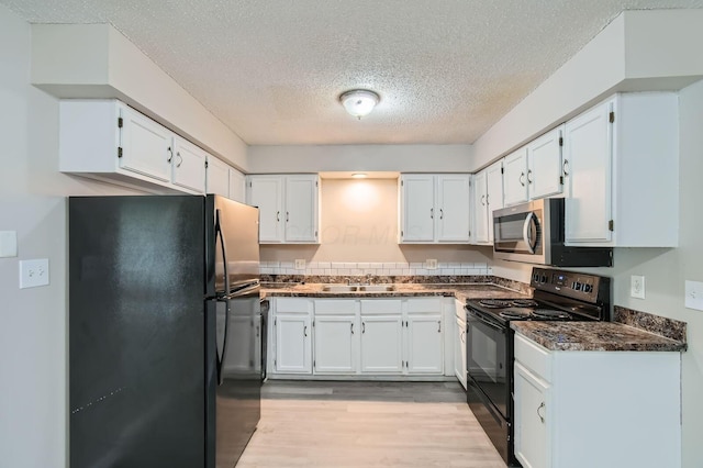 5359 Ivywood Ln, Columbus, OH 43229 - kitchen featuring black appliances, a textured ceiling, white cabinets, and light wood-type flooring