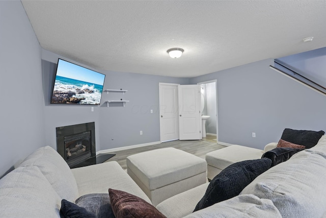 6310 Wagtail Rd Unit 6, Columbus, OH 43230 - living area with wood finished floors, baseboards, a textured ceiling, and a glass covered fireplace